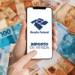 Celular mostrando aplicativo da Receita Federal para consulta do lote residual do Imposto de Renda 2026 com notas de real ao fundo