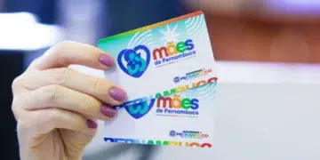 Cartão do programa Mães de Pernambuco segurado por uma mulher, representando o auxílio social de R$ 300 que será pago pelo Governo de Pernambuco no dia 9 de março.