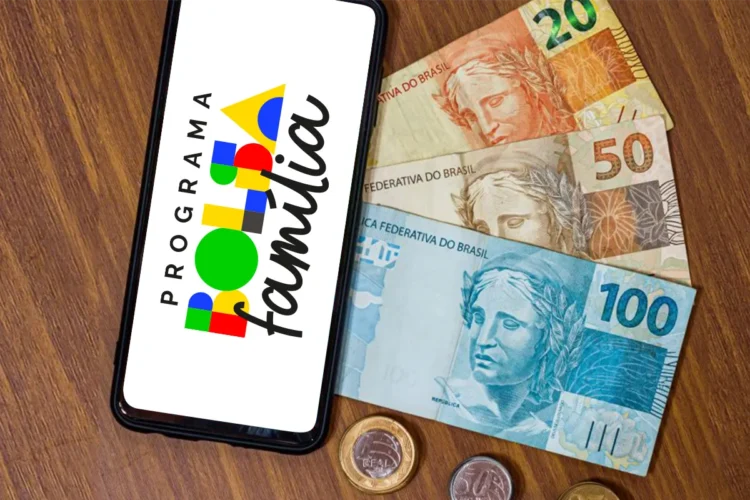 Bolsa Família: veja como consultar o valor de março no app a partir desta terça-feira (10) 1 Celular com logo do Programa Bolsa Família apoiado sobre notas de R$ 20, R$ 50 e R$ 100, representando o pagamento do benefício em março de 2026