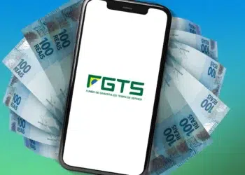 Smartphone exibe logo do FGTS cercado por notas de R$ 100 sobre fundo azul e verde gradiente.