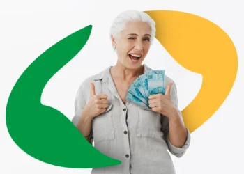 Mulher idosa de cabelos brancos sorri e faz sinal de positivo segurando notas de R$ 100, com logo estilizado ao fundo.